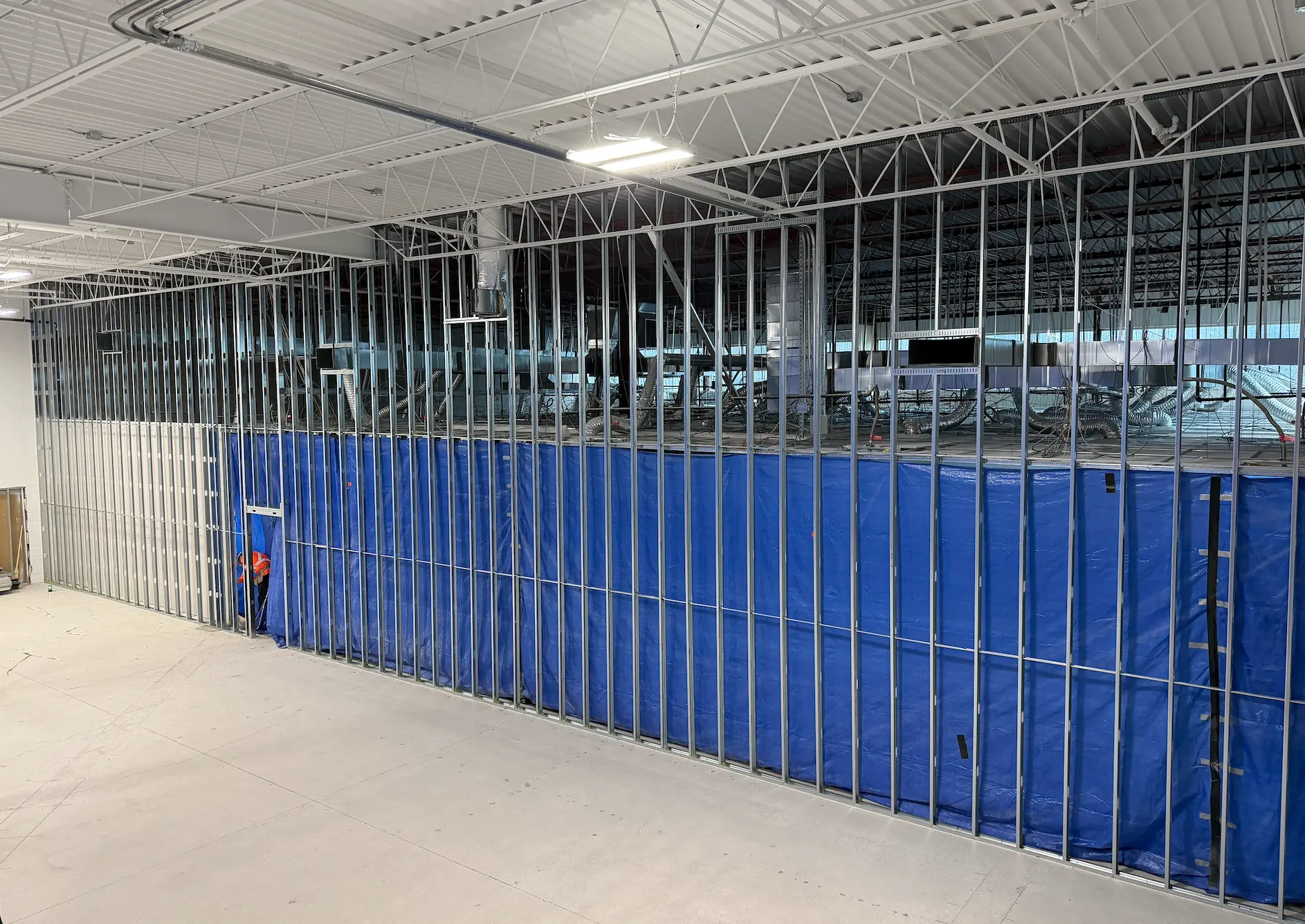 Steel framed demising wall with dust containment in a commercial interior