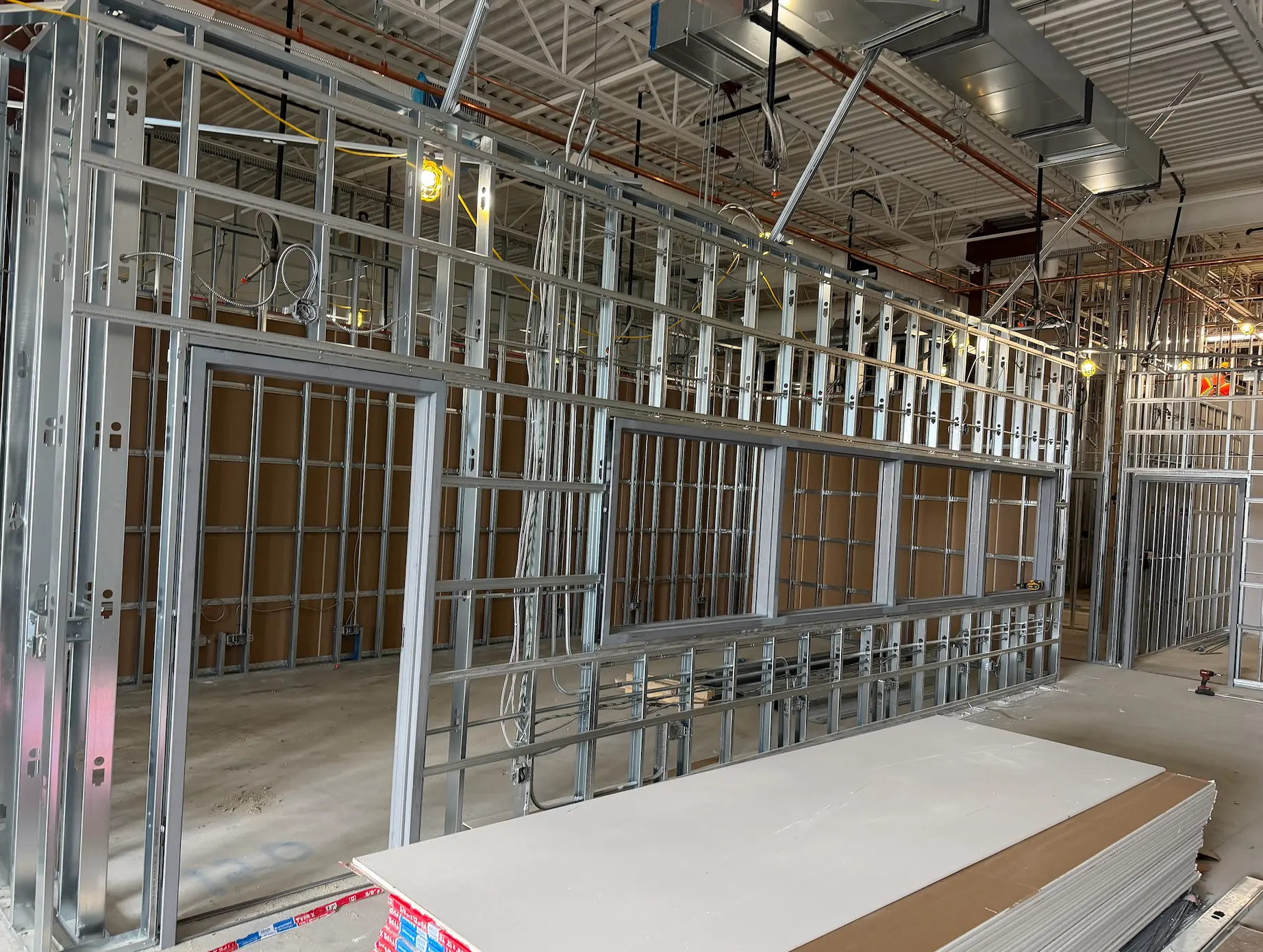 Steel stud partitions with door and window openings framed on a commercial fit-out