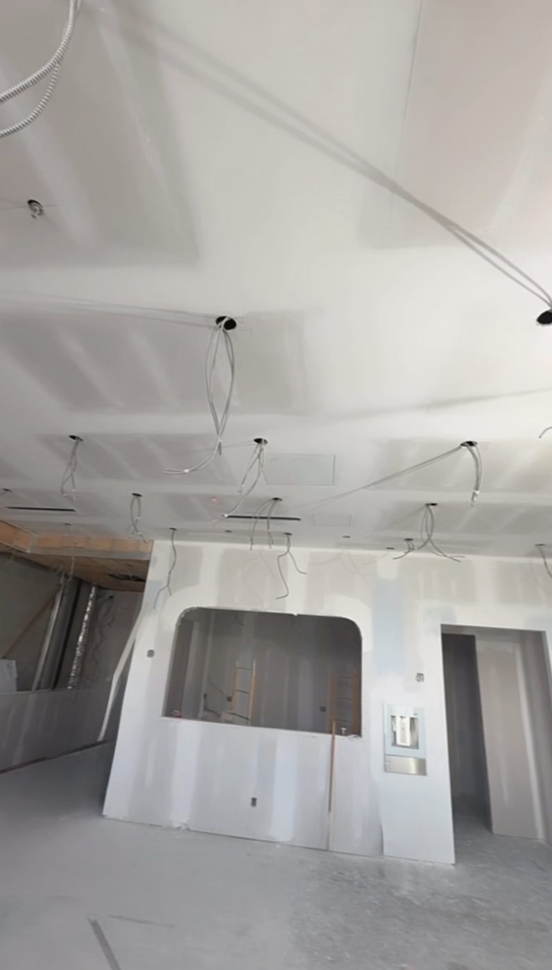 Taped drywall ceiling and archway ready for paint in a commercial fit-out