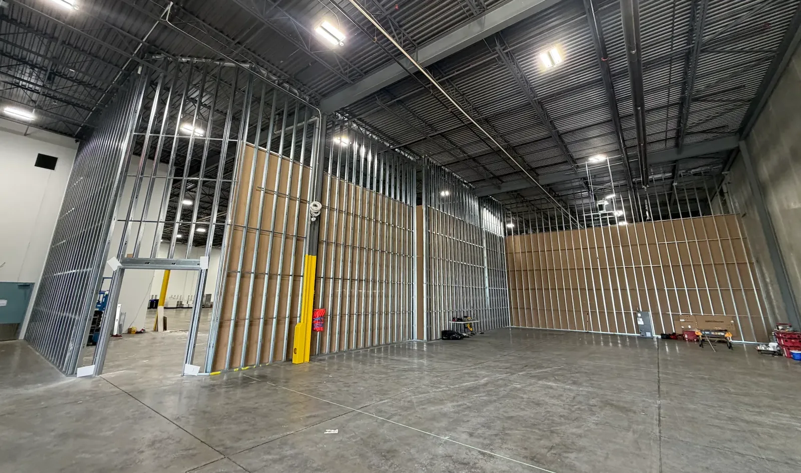 High-wall steel stud framing with sheathing in a Toronto warehouse build-out