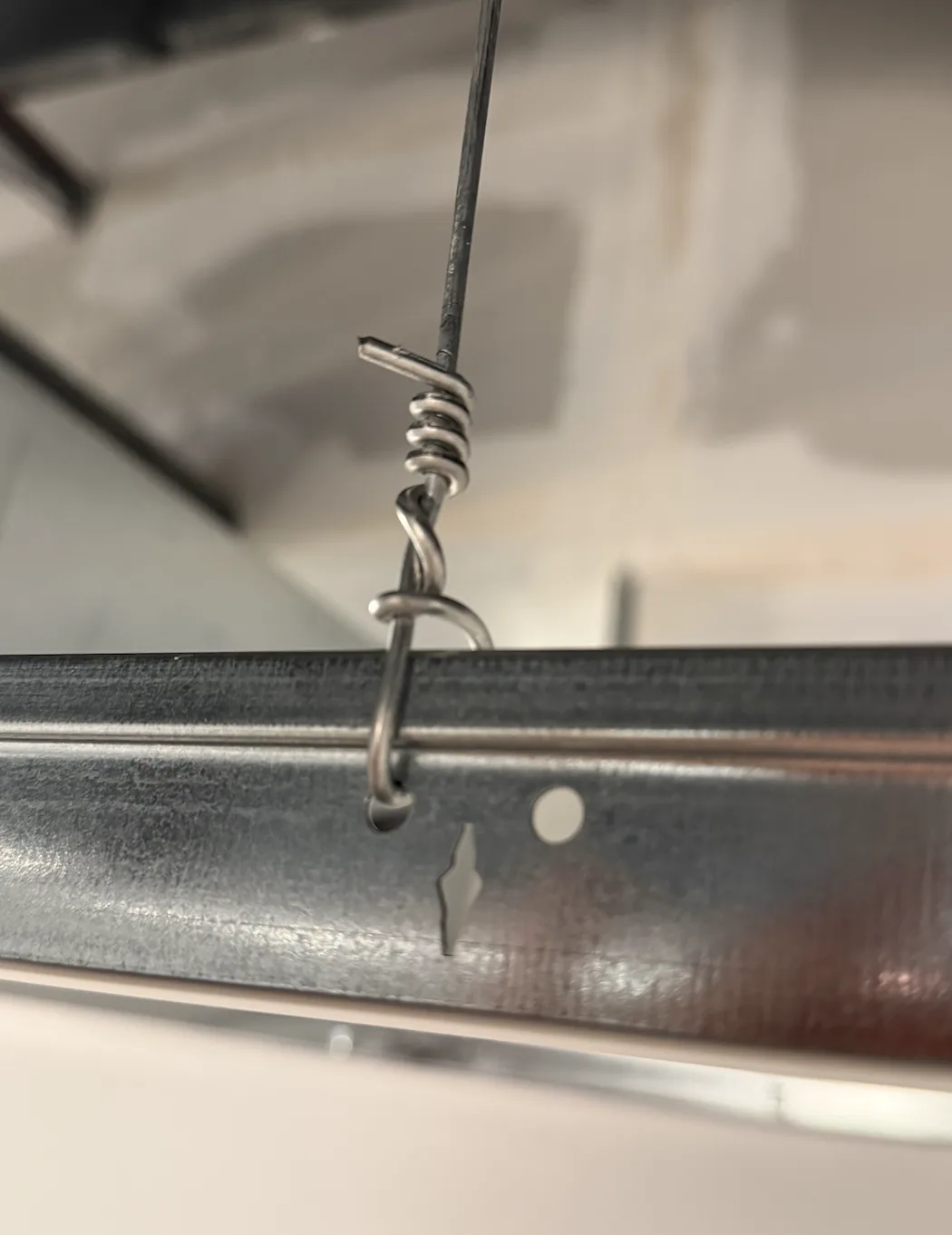 Ceiling hanger wire tied off to suspended grid framing
