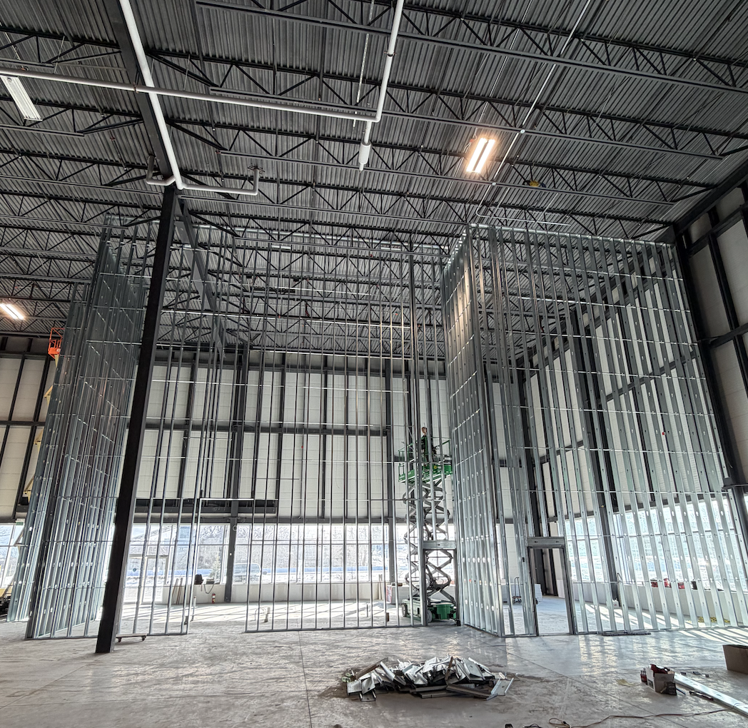 Tall steel stud framing under an open deck on a commercial project