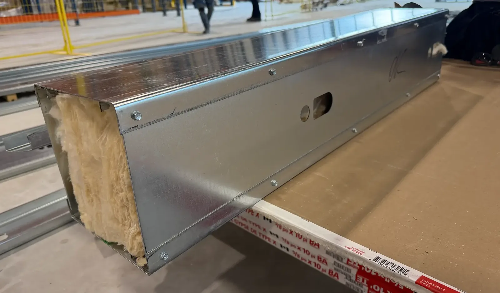 Fabricated insulated steel header assembly staged for installation