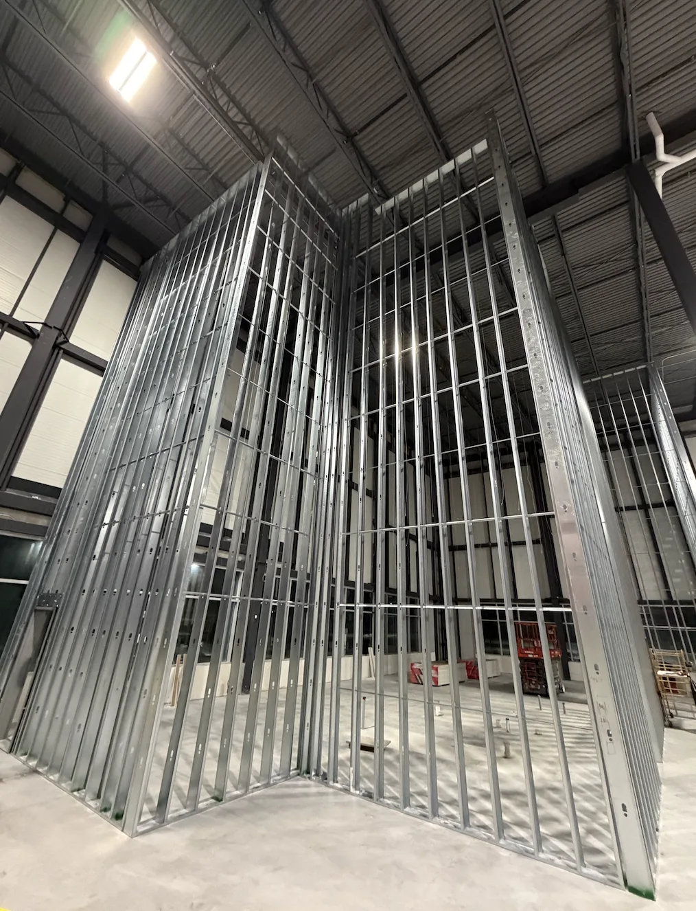 High-wall steel framing rising to an exposed deck in a warehouse