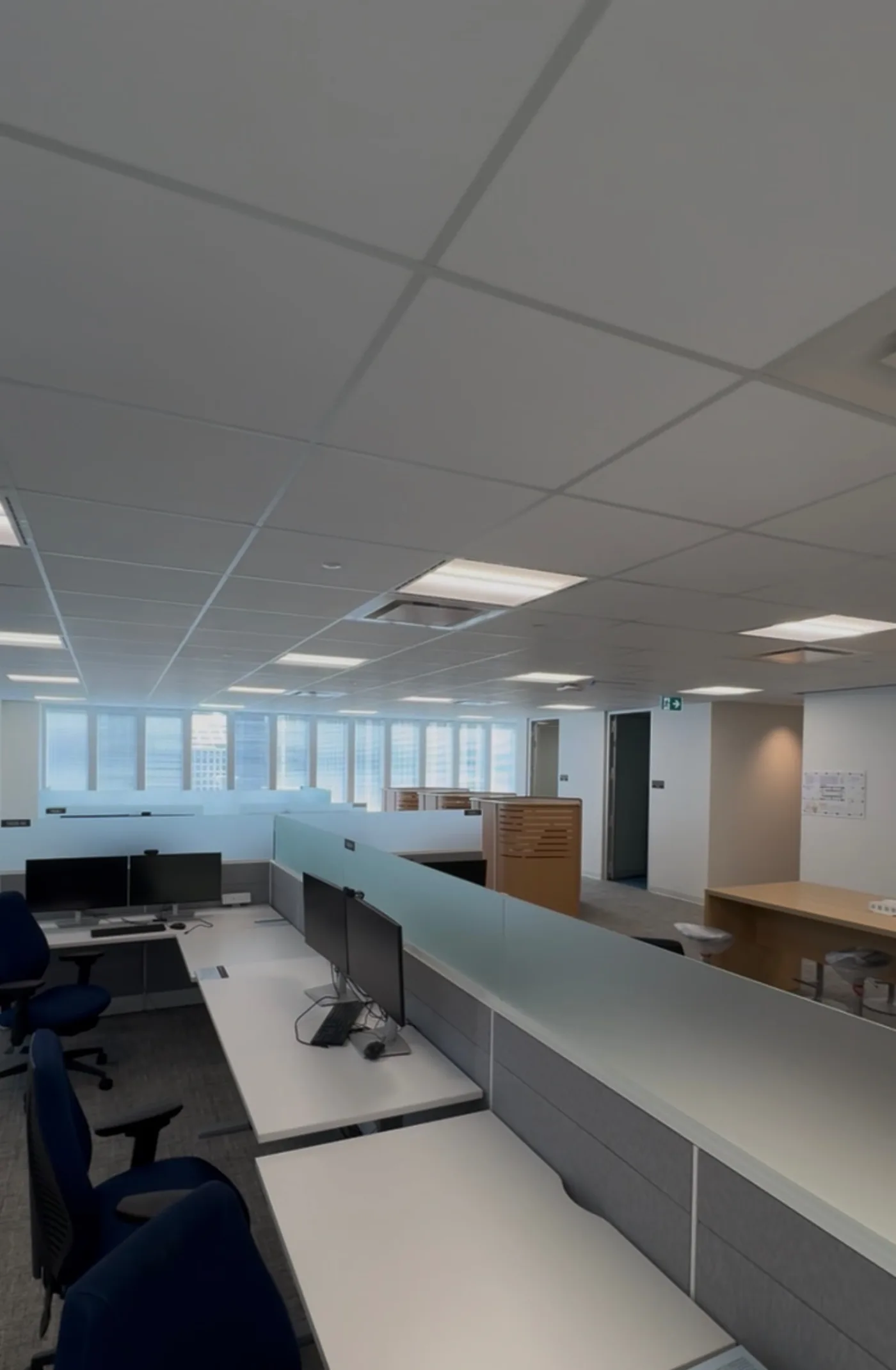 Open-plan office with completed suspended grid ceiling and lighting
