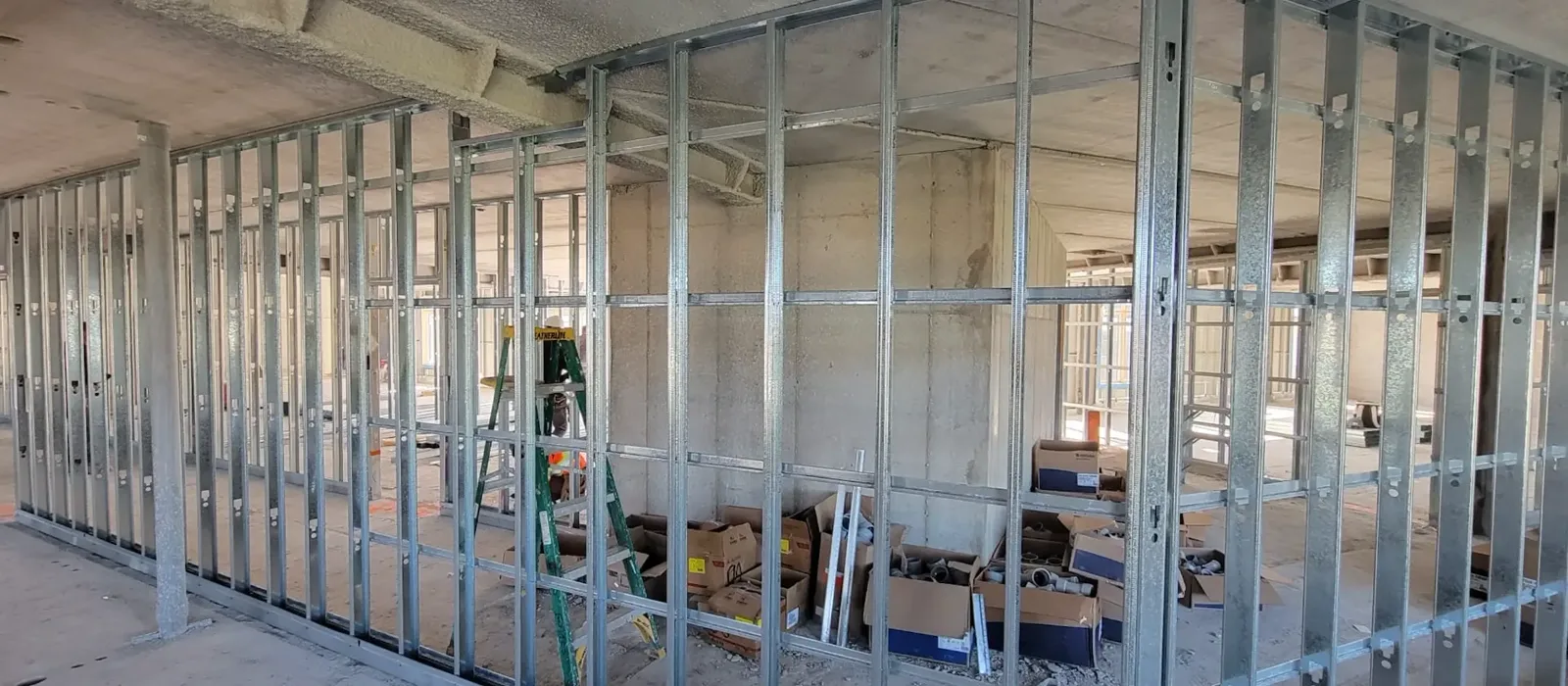 Light-gauge steel framing partitions on a concrete floor plate