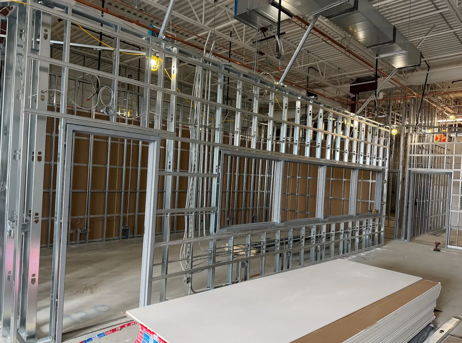 Steel framed office partitions with window and door openings on a commercial fit-out