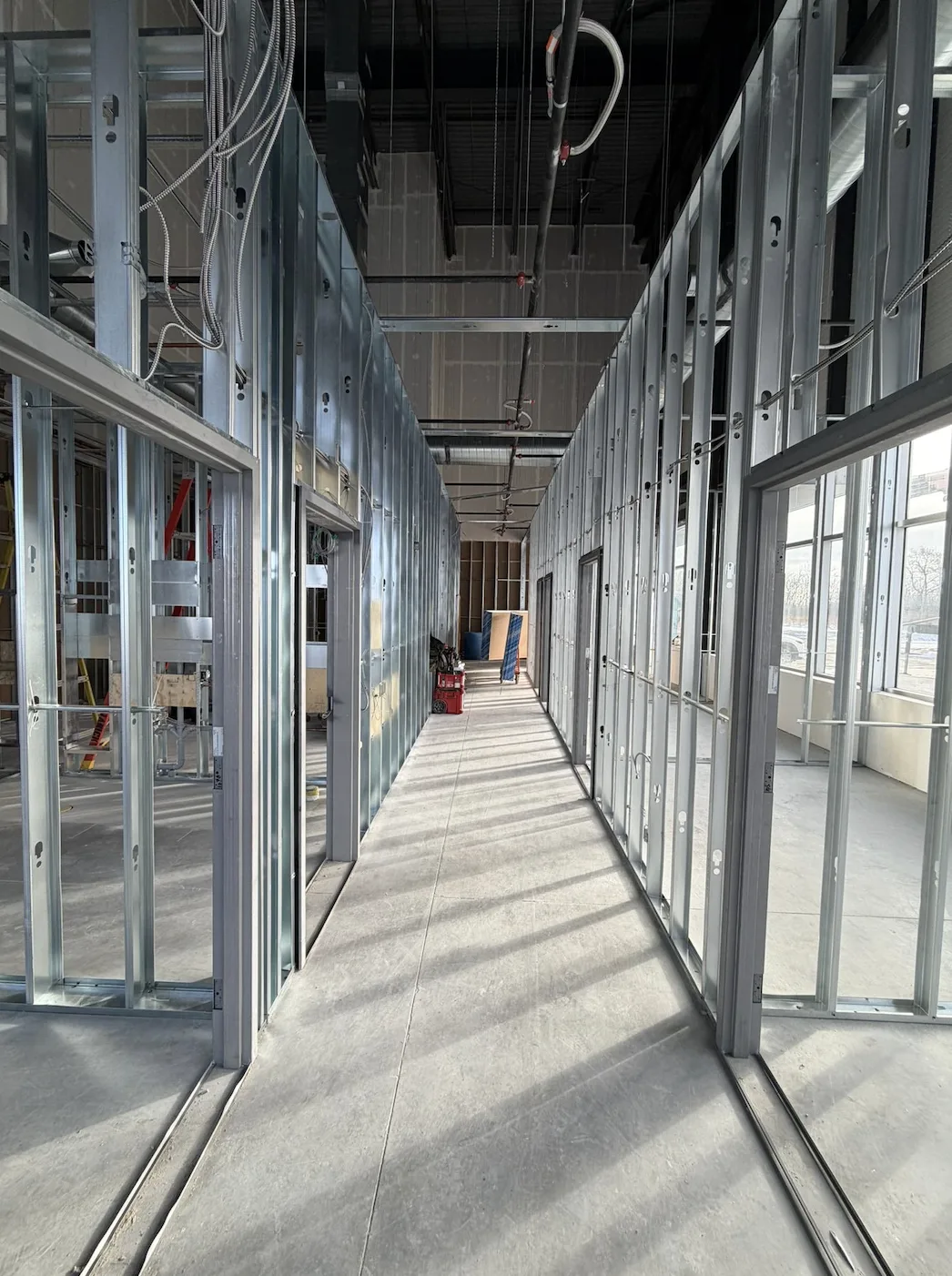 Steel stud corridor framing with door openings in a commercial build-out
